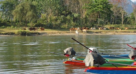 Panoramic view of Vang Vieng’s scenic landscape for a scenic Vang Vieng Tours banner by Legend Travel Group.